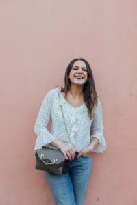 White Polka Dot Top Worn With Blue Girlfriend Jeans Against A Pink Wall Backdrop | Monica Beatrice Welburn | The Elgin Avenue Blog