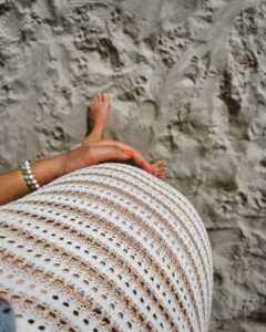 Monica Welburn-Leggett 32 week baby bump in crochet neutral dress
